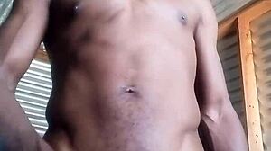 Horny amateur kneels to masturbate big black cock with huge balls