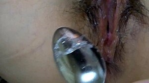 Close-up shots of Asian wife's wet pussy while watching porn
