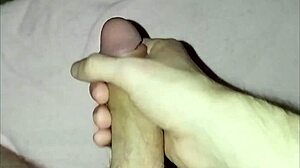 a young guy plays with his dick solo