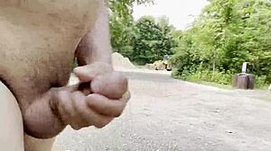 Gay man strokes big cock solo in woods