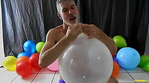 Richard Lennox, a hot and wealthy DILF, enjoys balloon fetish play
