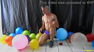 Richard Lennox, a hot and wealthy DILF, enjoys balloon fetish play