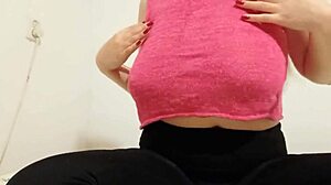 The teen cowgirl in a pink top rides outdoors, playing with her big boobs until orgasm