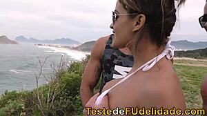 Beautiful woman enjoys sensual massage with coconut oil on the beach with two men