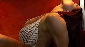 Muscular bodybuilder flaunts big tits in tiny bikini