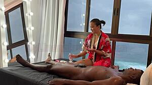 Asian masseuse gives a relaxing massage to a black man