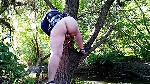 Horny BBW milf fingers herself with toys outdoors, legs high