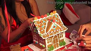 Girlfriend and friend make gingerbread house for christmas