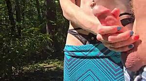 Wife sneaks quick handjob during walk with pierced nipples showing