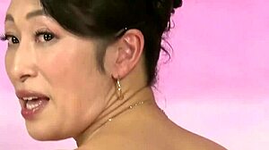 Reiko, mature Asian star, dominates in wild JAV action with intense moves.