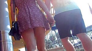 In this public outdoor scene, a skirt flies up in slow motion for an upskirt view