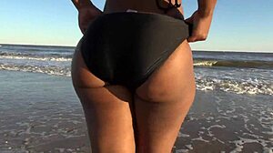 Ebony woman dances naked on the beach