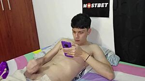 Young Colombian jerks off to Spanish porn on his phone, but his stepmom joins in?