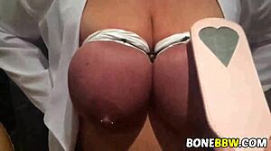 Big tits are slapped and fucked in a garage BDSM scene