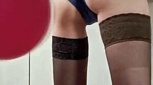A sexy mistress plays with balloons in a tantalizing way