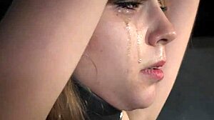 A beautiful girl is in bondage and is roughly taken