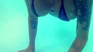 MELISSA THE MERMAID SWIMS IN POOL WITH TATTOOS BROWN EYES