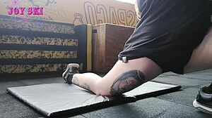 Tattooed Alternative Young Girl Stretching Exercises At The Gym