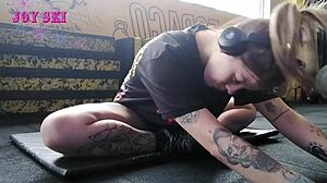 Tattooed Alternative Young Girl Stretching Exercises At The Gym