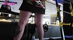 Tattooed Alternative Young Girl Stretching Exercises At The Gym