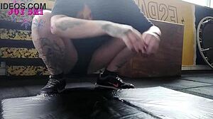 Tattooed Alternative Young Girl Stretching Exercises At The Gym