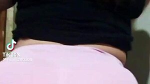 The mature prostitute with a big ass shows off her marked panties while teasing her clients