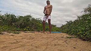 African Guy Jerks Off And Cums On The Beach!
