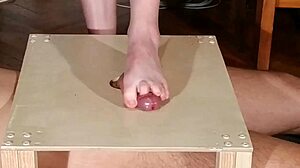 Domina stomps cock with bare feet