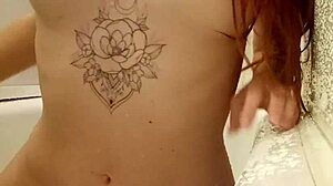 redhead teen 18+ relaxes in the bath with tattoos