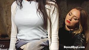 Bent over lesbian slave with big tits endures strapon punishment in bondage bdsm scene