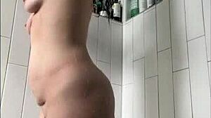 Milf with tattoo masturbates in shower, focusing on wet tits, big clit, ass, and pussy