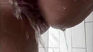 Milf with tattoo masturbates in shower, focusing on wet tits, big clit, ass, and pussy
