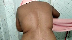 Hot brunette mom shows off big natural tits while bathing.