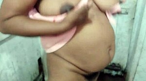 Hot brunette mom shows off big natural tits while bathing.