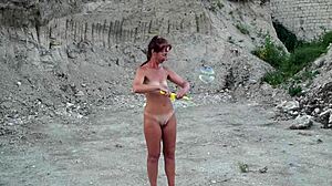 naked mature milf wife playing with soap bubbles outdoors