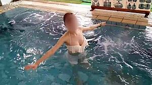 Skinny girl exercises her legs in the pool