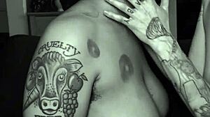 Dom dyke spits in sub stud's mouth during rough lesbian play. Tattooed queer couple gets sloppy with intense kisses.