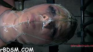 restrained slut receives castigation for naughty pussy