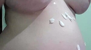 Pregnant wife enjoys a creamy massage in blonde lingerie