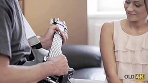 Old guitarist lets young fan play his instrument