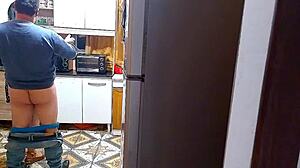 The wife cheats in the kitchen with her lover.