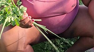 Curvy ebony believer tends to the church garden with care
