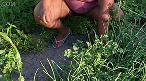 Curvy ebony believer tends to the church garden with care