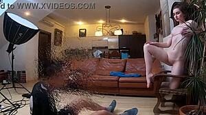 Naked model poses during intimate photoshoot.