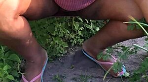 Curvy ebony believer tends to the church garden with care