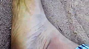 Barefoot model poses feet in the sand for nature photography