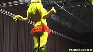 Whoa, check these babes sharing cock on the public sex fair stage! 😏