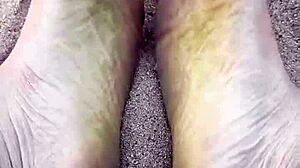 Barefoot model poses feet in the sand for nature photography