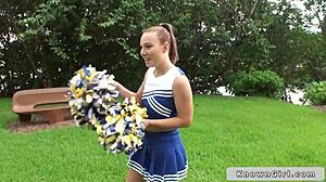 Busty cheerleader shows off outdoors.
