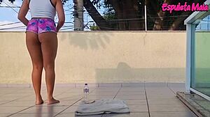 brunette trains outdoors with shorts up her ass